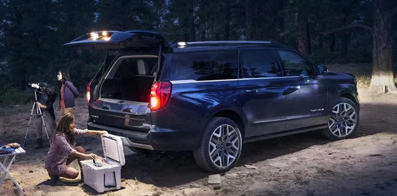 A family watching the stars standing behind a 2025 Ford Expedition.