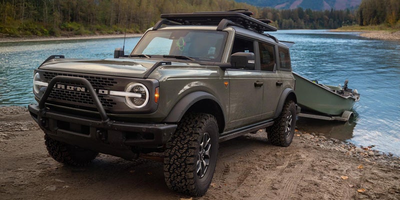 Grey 2026 Ford Bronco towing small boat from river